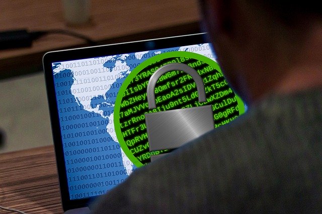 Image on laptop screen of world map overlaid with padlocked code, representing how knowing what to do after a security breach is critical for businesses in the digital age.