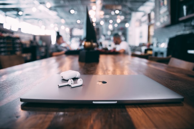 Image of a MacBook on a table in public, representing the need for small businesses to protect systems in an age of remote work and how to choose the right VPN for the job.